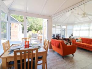 a living room with a table and chairs at Pinecote Cottage in Nottingham