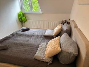 a bedroom with a large bed with pillows on it at Appartement-Koblenz in Koblenz