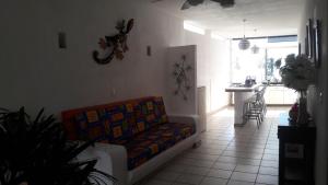 a living room with a couch and a kitchen at Hotel Casa Chacala in Chacala