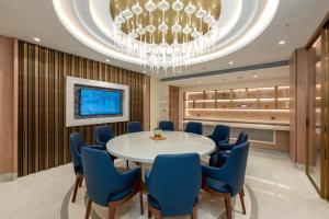 a dining room with a table and blue chairs at Hotel Express Inn Heritage Aurangabad Airport in Aurangabad