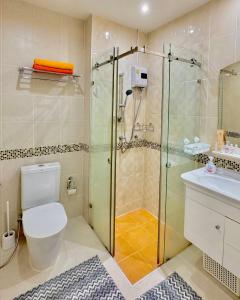 a bathroom with a shower and a toilet and a sink at Супер апартаменты Найтон Naithon in Nai Thon Beach