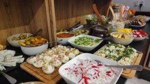 a buffet with many different types of food on a table at Hotel Nenufar in Kościan
