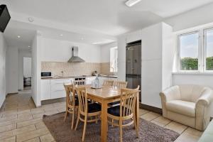 a kitchen and dining room with a table and chairs at Green House Copenhagen in Copenhagen