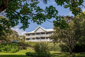 an external view of a building with trees at Caves House Apartments Yallingup in Yallingup