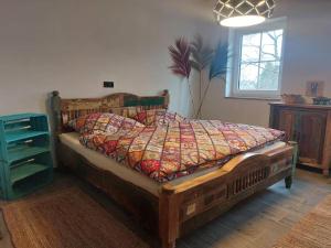 a bedroom with a bed with a quilt on it at Little-Lama-Lodge in Naila