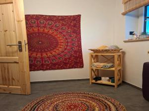 a red tapestry hanging on a wall next to a door at Little-Lama-Lodge in Naila