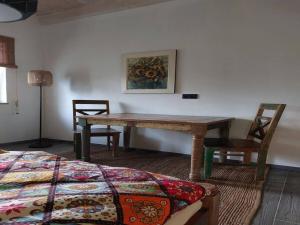 a room with a table and two chairs and a bed at Little-Lama-Lodge in Naila