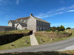 a large brick house on the side of a road at 10 The Downs, Thurlestone overlooking Burgh Island in Kingsbridge