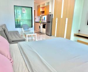a bedroom with a large bed and a kitchen at Супер апартаменты Найтон Naithon in Nai Thon Beach