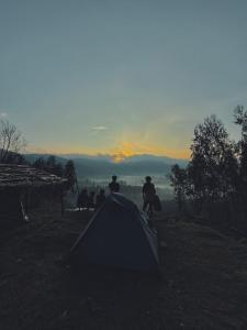 a group of people standing around a tent at Apm resort kodai in Kodaikānāl
