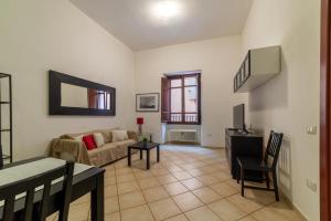 a living room with a couch and a table at Sardinian Gallery Corso in Bosa