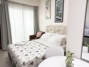 a white bedroom with a bed and a couch at Inspiria Condominium in Davao City +46 photos