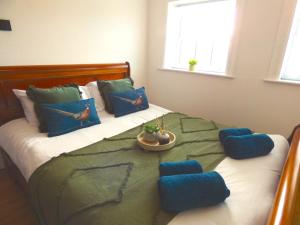 a bedroom with a large bed with blue pillows at Entire home in perfect old town location in Hull