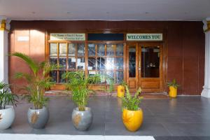 a store front with four vases with plants in them at Klite stays - ZomoHotels in Pondicherry