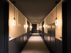 a hallway with lights and a long corridor at R Hotel Nagoya Station in Nagoya
