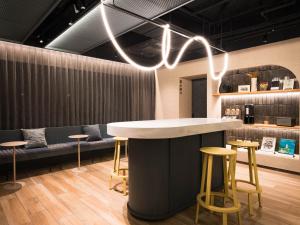 a bar with stools and a counter in a room at R Hotel Nagoya Station in Nagoya