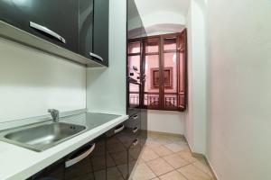 a kitchen with a sink and a window at Sardinian Gallery Corso in Bosa +54 photos