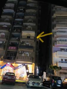 a yellow arrow is flying over a tall building at الملاحه in Suez