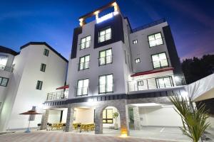 a large white building with a lot of windows at Samcheok blossom pension in Samcheok