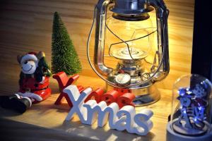 a christmas sign next to a lantern and a christmas tree at Samcheok blossom pension in Samcheok