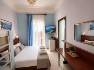 a bedroom with a bunk bed and a desk and a window at Diethnes Hotel in Athens