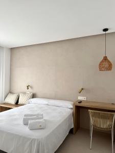 a bedroom with a bed and a desk and a chair at Santuario San José in San José +51 photos