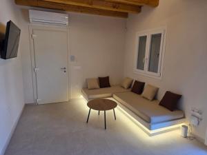a living room with a couch and a table at Apsila Suites Mykonos in Mikonos
