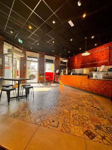 a dining room with a table and chairs on a tile floor at Urban City Centre Hostel in Brussels