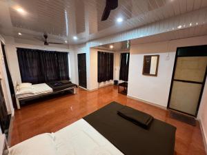 a living room with a couch and a table at Beach Side Home Stay - Kihim in Kīhīm