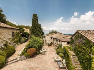 an aerial view of a village with buildings and trees at Borgo Vescine in Radda in Chianti