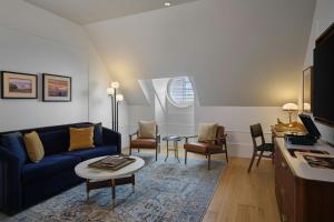 a living room with a blue couch and a table at Asher Adams, Autograph Collection in Salt Lake City