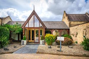 a house with a conservatory with glass doors at Shendish Manor Hotel & Golf Course in Hemel Hempstead +103 photos