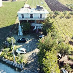 an aerial view of a house with cars parked in front at Camping BORA in Cërrik