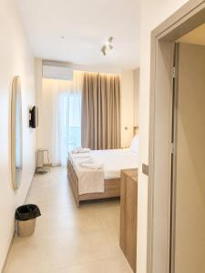 a hotel room with a bed and a window at UrbanBay Hotel & Spa in Kavála
