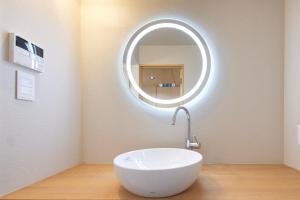 a bathroom with a white sink and a mirror at nedoko in Sumoto +46 photos