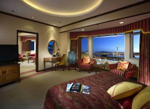 a hotel room with a bed and a large window at Hotel Lisboa in Macau