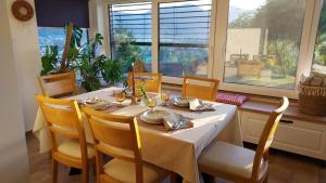 a dining room with a table and chairs and a window at Apartma AURA in Slovenske Konjice +32 photos