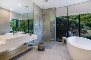 a bathroom with a tub and a sink and a shower at Blue Range Estate Villas in Rosebud