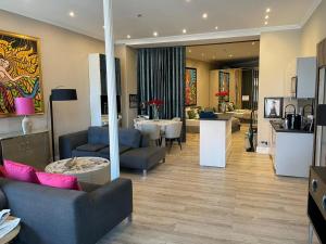 a living room with couches and a dining room at Modern Suite in the Taunus in Bad Camberg +48 photos