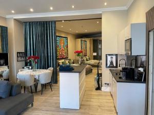 a kitchen and living room with a table and a couch at Modern Suite in the Taunus in Bad Camberg