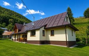 a house with a metal roof at Chata Huta in Muránska Huta