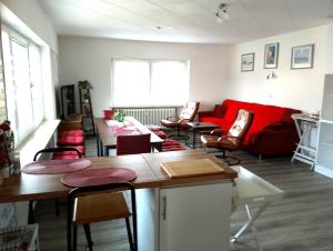 a living room with a red couch and chairs at Ferienwohnung Jahnke in Burkardroth