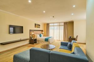 a hotel room with a couch and a bed at Best Western Premier Dynasty in Addis Ababa