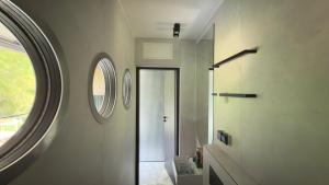 a bathroom with a round window and a white wall at Floatel Vilnius in Vilnius