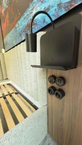 a room with a bed and a tv on a wall at Floatel Vilnius in Vilnius