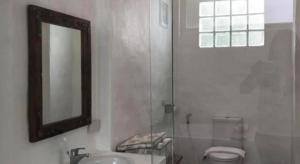 a bathroom with a toilet and a sink and a mirror at Samunthitar Resort in Khao Kho +105 photos
