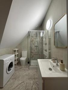 a bathroom with a sink and a washing machine at Willa przy Czarnej Bramie in Kłodzko +91 photos