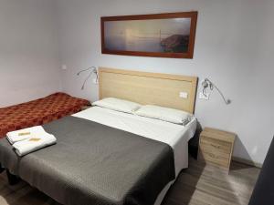 Llit o llits en una habitació de Hotel Galla
