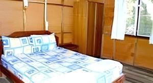 a bed with blue and white pillows in a room at Green Valley Resort in Tonsai Beach