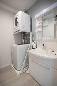 a white bathroom with a sink and a microwave at Ocean Front! New Built Apartment! SOU Resort YAKA in Kin +42 photos